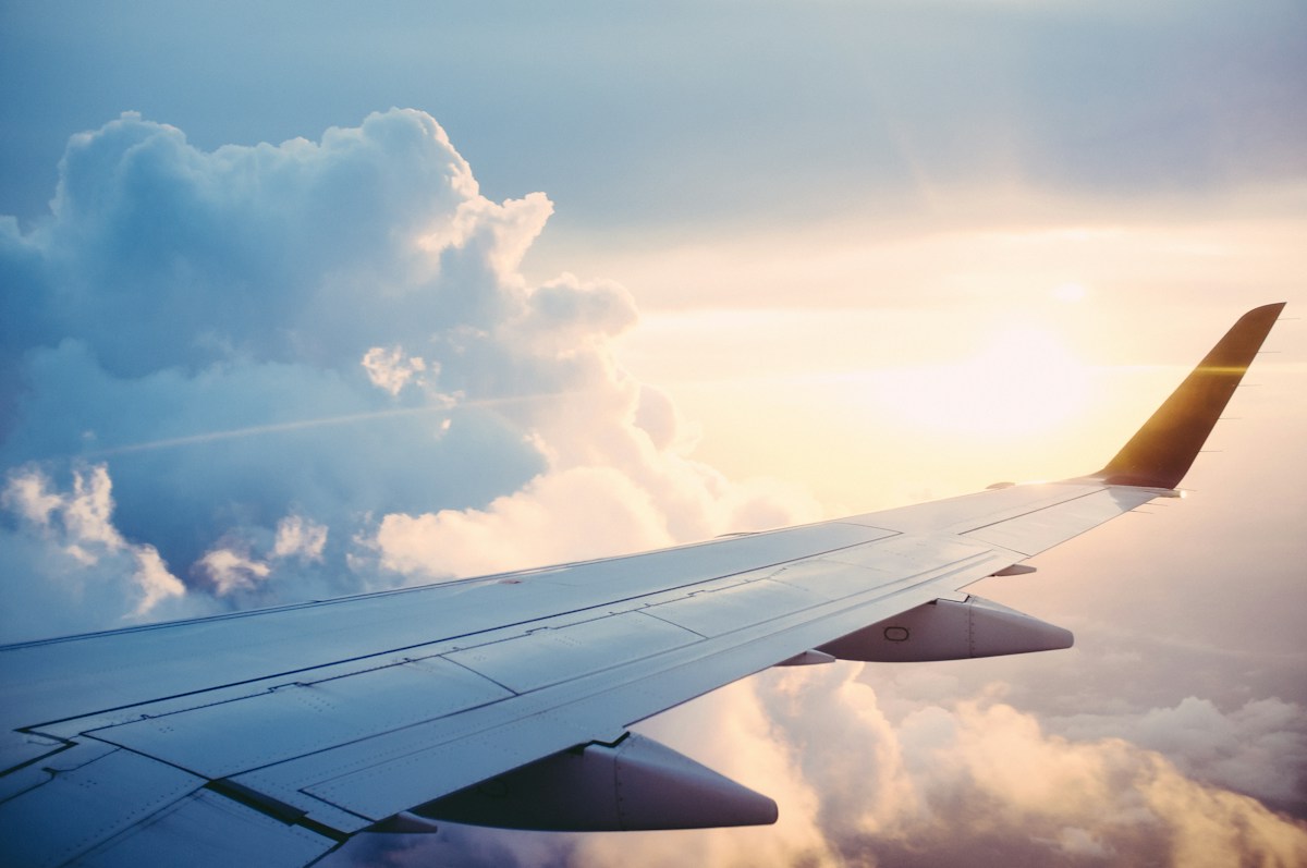 Aircraft wing above clouds, illustrative aviation photograph